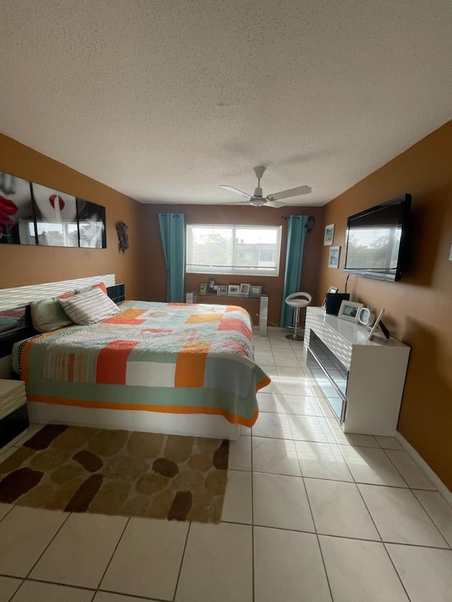 tiled bedroom featuring a textured ceiling and ceiling fan