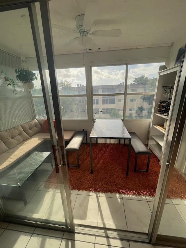 sunroom featuring ceiling fan