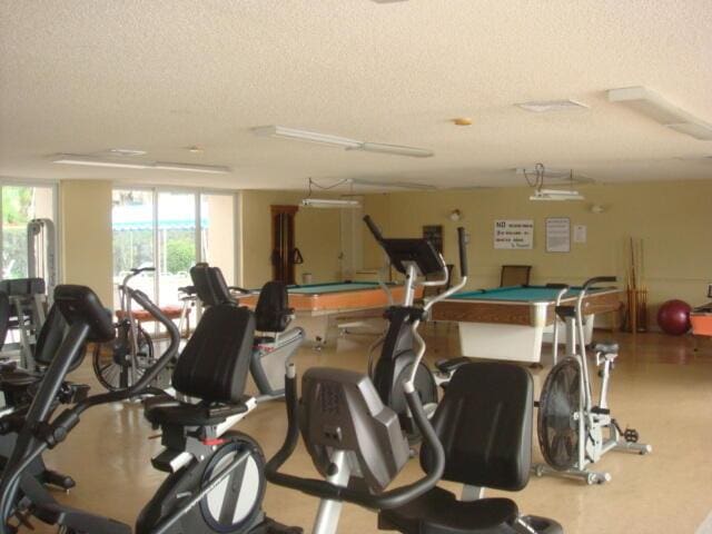 workout area with a textured ceiling and billiards