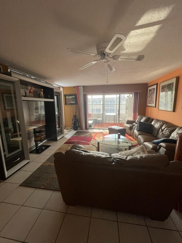 tiled living room with ceiling fan and a textured ceiling