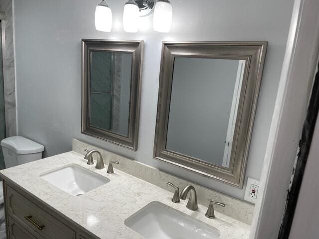 bathroom featuring vanity and toilet