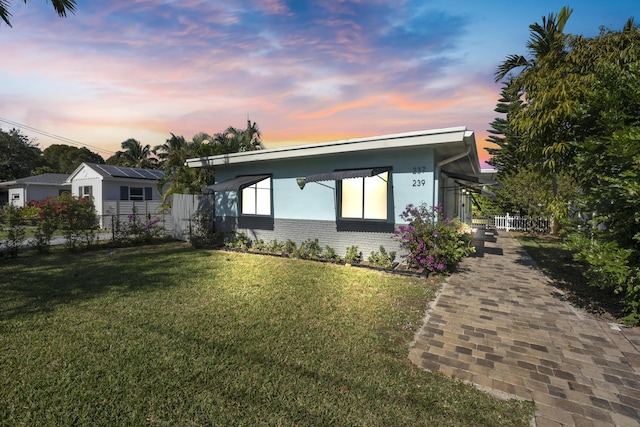 view of front of property with a lawn