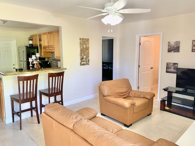 tiled living room featuring ceiling fan