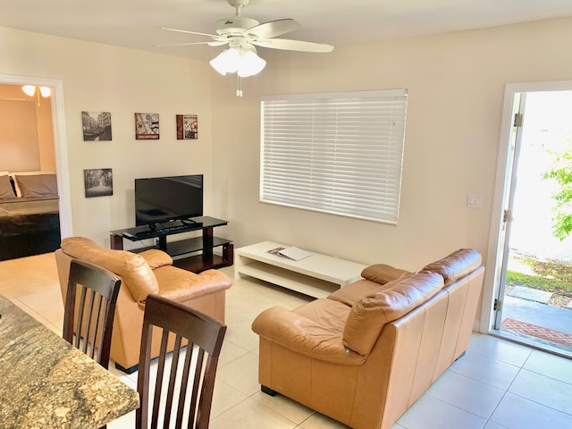 tiled living room with ceiling fan and a healthy amount of sunlight