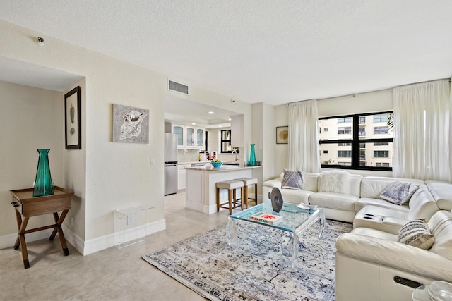 living room with sink and a textured ceiling