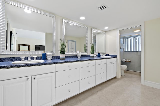 bathroom featuring toilet and vanity