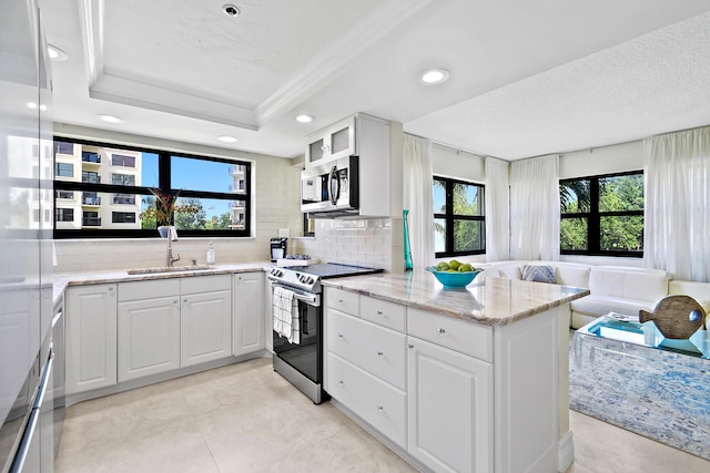 kitchen with sink, white cabinets, a raised ceiling, and appliances with stainless steel finishes