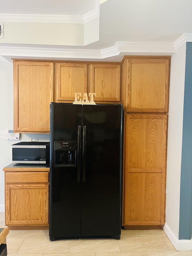 kitchen featuring black fridge with ice dispenser and crown molding