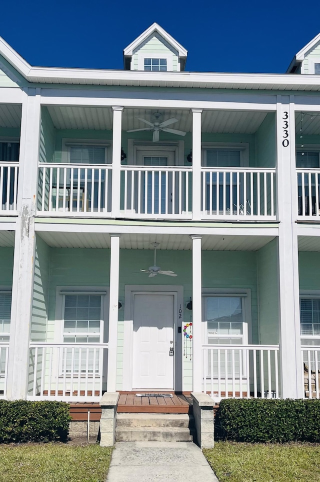 exterior space featuring ceiling fan, a porch, and a balcony