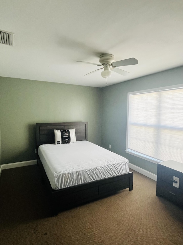 bedroom featuring ceiling fan and carpet