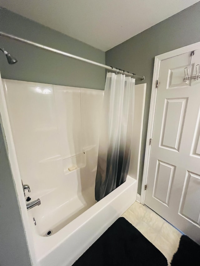 bathroom with tile patterned floors and shower / tub combo