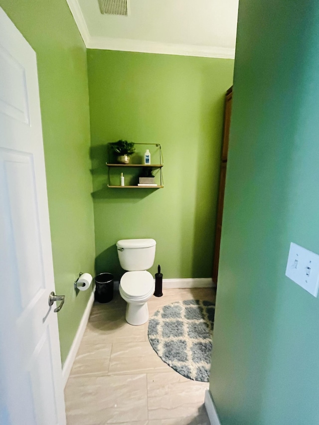 bathroom with toilet and ornamental molding