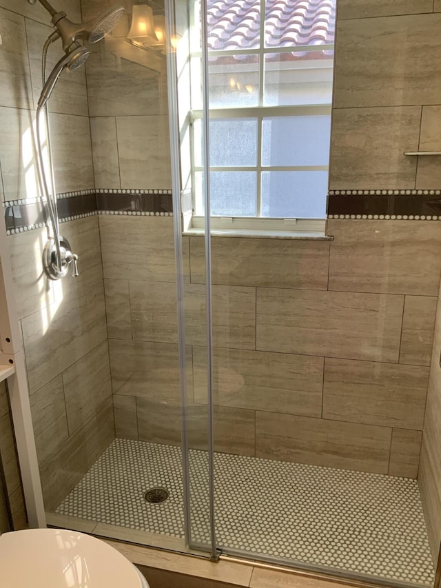 bathroom with an enclosed shower and toilet