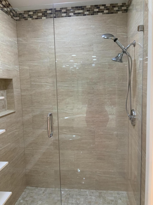 bathroom with a shower with shower door