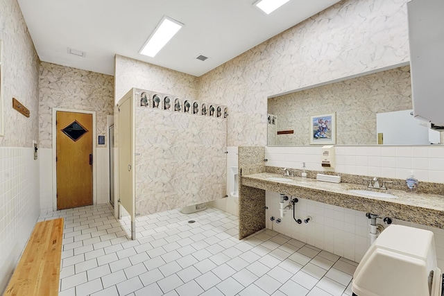 bathroom featuring tile patterned flooring and tile walls