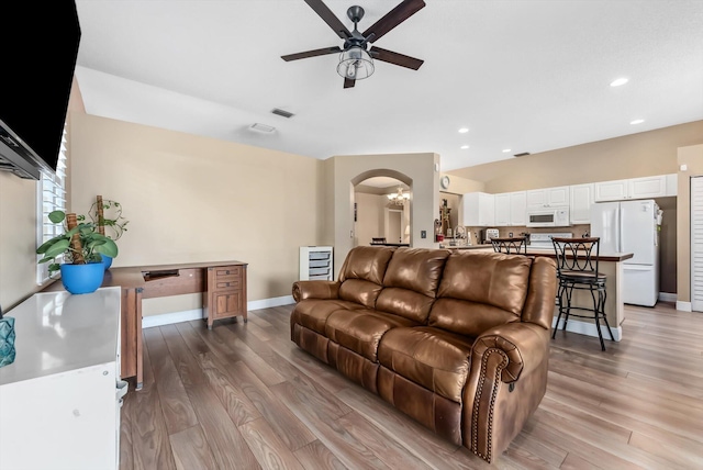 living room with ceiling fan and light hardwood / wood-style floors