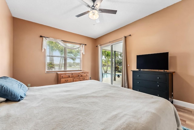 bedroom featuring ceiling fan, wood-type flooring, and access to exterior