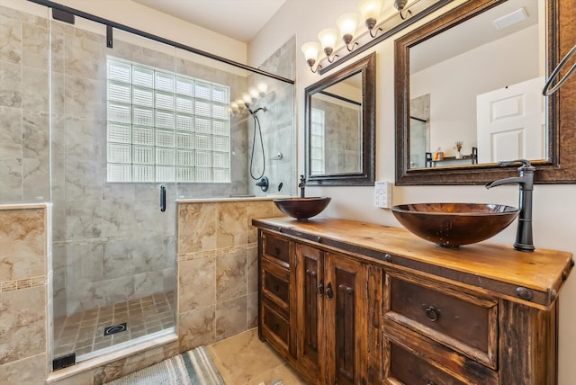 bathroom featuring a shower with door, tile patterned floors, and vanity