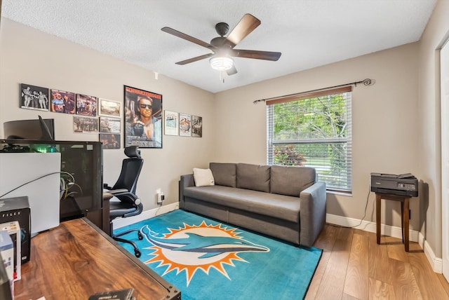 home office with wood-type flooring, a textured ceiling, and ceiling fan