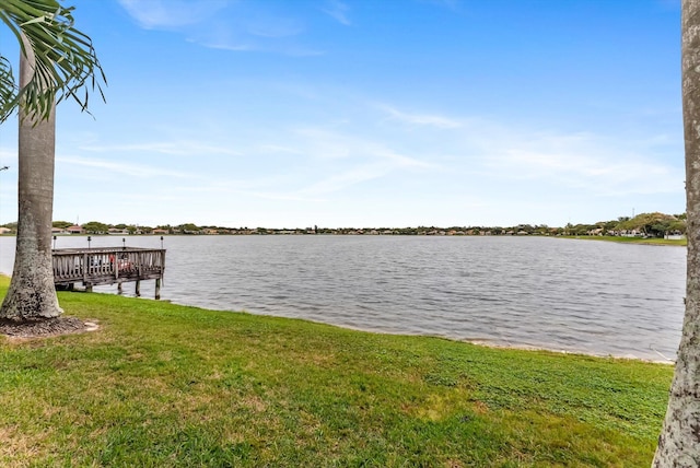 dock area featuring a lawn and a water view