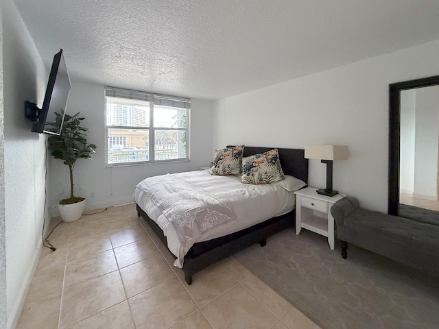 tiled bedroom with a textured ceiling