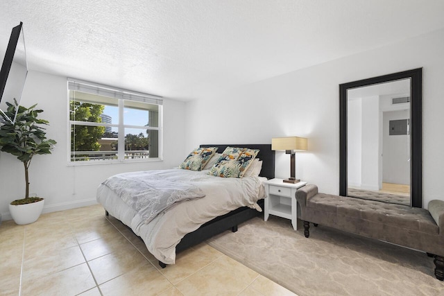 bedroom featuring a textured ceiling and light tile patterned flooring