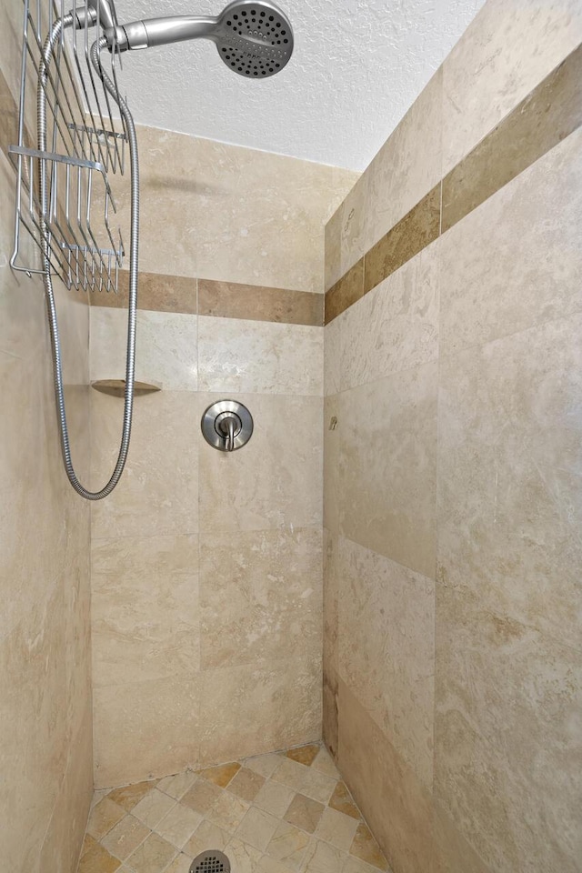 bathroom with a tile shower