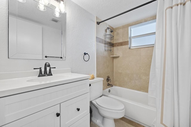 full bathroom with a textured ceiling, toilet, shower / bath combo, and vanity