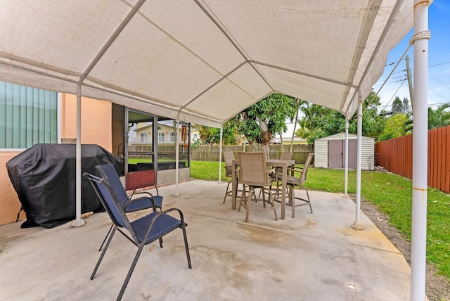 view of patio / terrace with grilling area and a shed