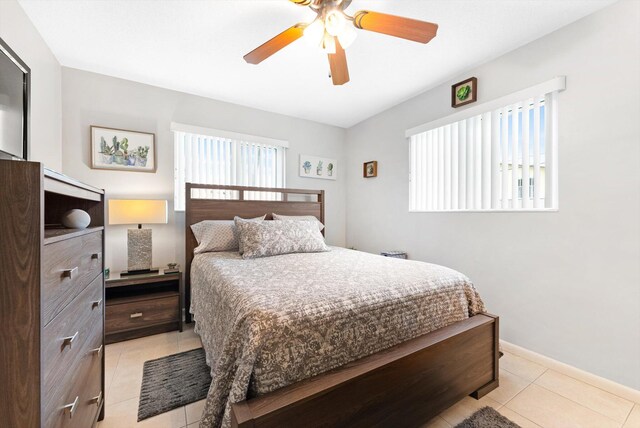 tiled bedroom with ceiling fan