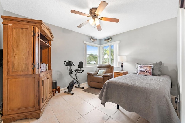 tiled bedroom featuring ceiling fan