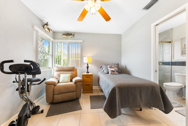 bedroom with ceiling fan, ensuite bathroom, and light tile patterned floors