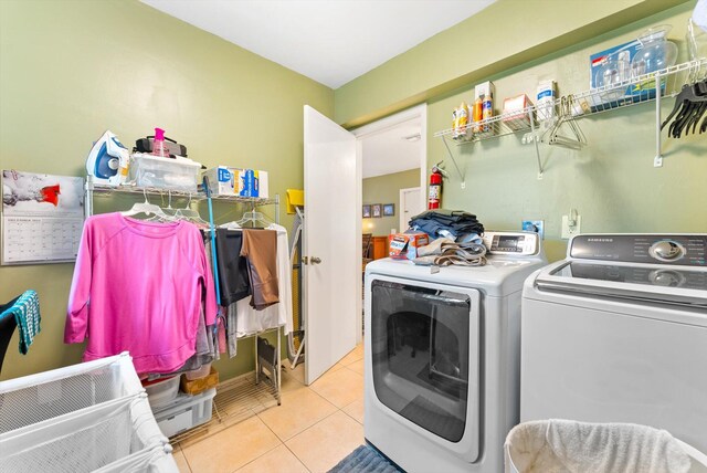 washroom featuring washer and dryer and light tile patterned floors