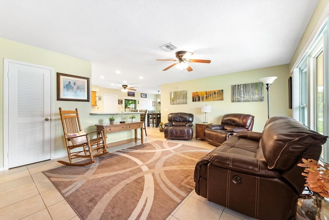 tiled living room with ceiling fan