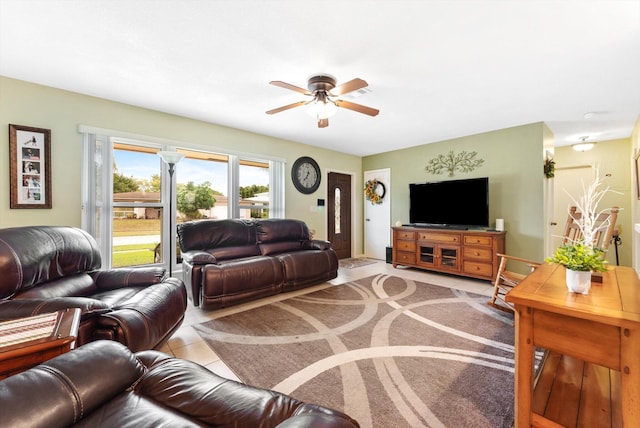 tiled living room with ceiling fan