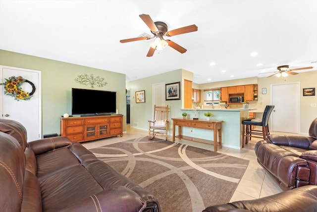 living room featuring ceiling fan and light tile patterned floors