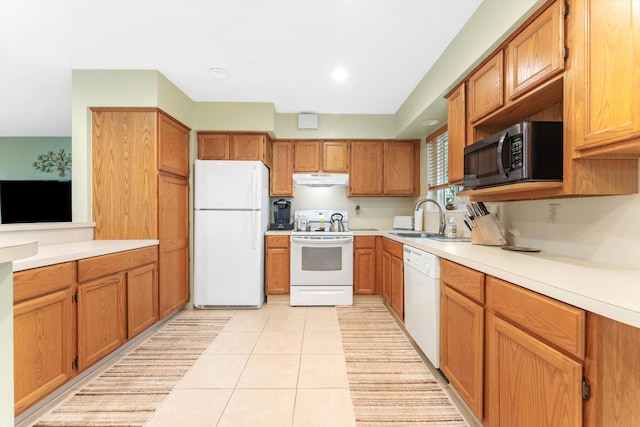 kitchen featuring white appliances, sink, and light tile patterned floors