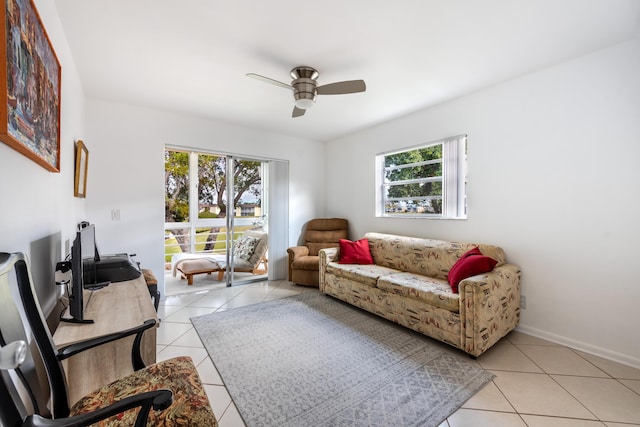 living room with a healthy amount of sunlight, light tile patterned floors, and ceiling fan