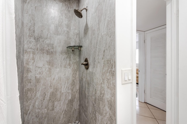 bathroom with curtained shower and tile patterned floors