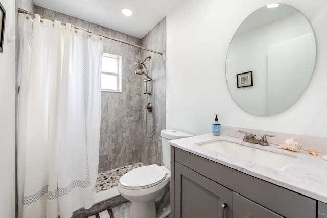 bathroom featuring vanity, toilet, and a shower with shower curtain