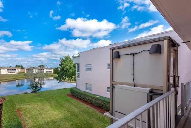 view of home's exterior with a water view and a yard