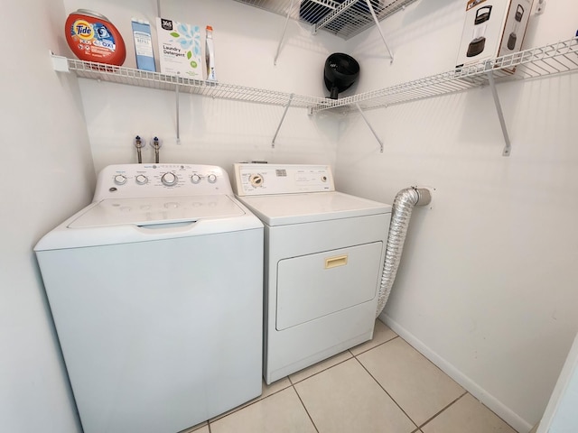 washroom featuring light tile patterned floors and washer and dryer