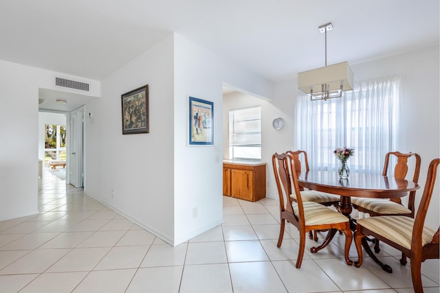 dining space featuring an inviting chandelier and light tile patterned floors