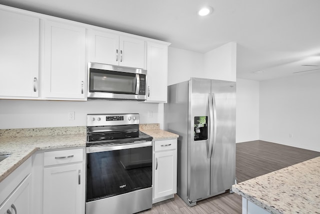 kitchen featuring stainless steel appliances and white cabinetry