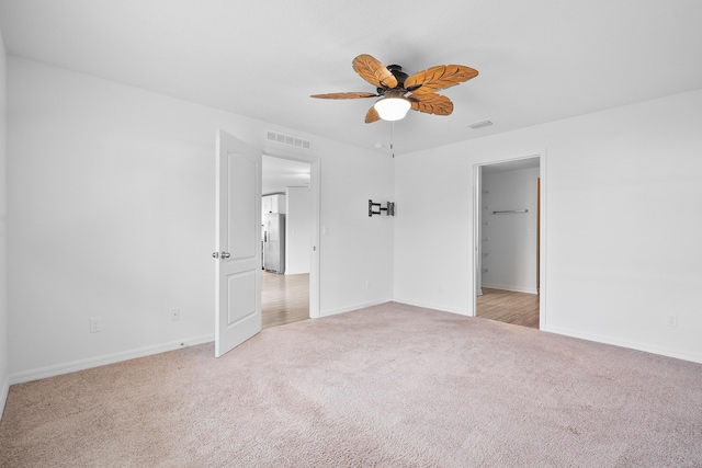 unfurnished bedroom with light carpet and ceiling fan