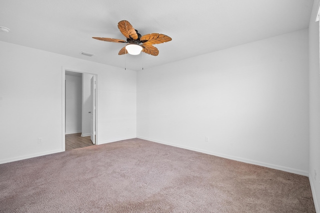 unfurnished room featuring ceiling fan and carpet