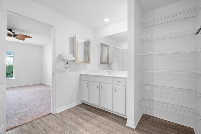 bathroom featuring ceiling fan, vanity, and hardwood / wood-style floors