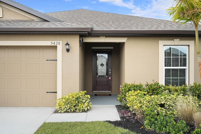 view of exterior entry with a garage