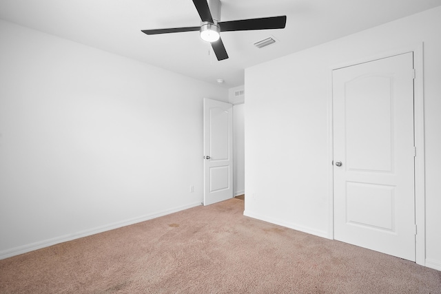 unfurnished bedroom with ceiling fan and light carpet