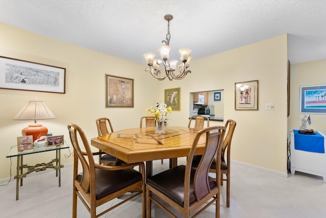 dining area featuring a notable chandelier and a textured ceiling